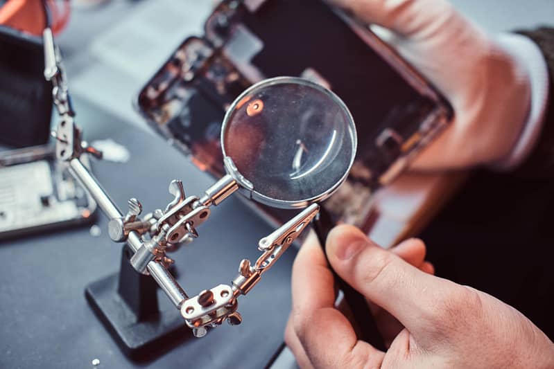 technician carefully inspect the internal parts of T72F8BE