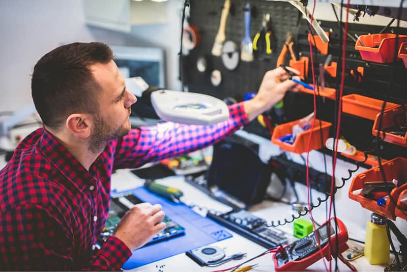 man repairing laptop at workplace 73ZB33V